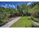 Landscaped backyard with a pathway, offering a serene retreat in a well-maintained outdoor space at 208 Haven Beach Ct, Indian Rocks Beach, FL 33785