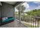 Screened balcony featuring comfortable seating and scenic views of the water and palm trees at 208 Haven Beach Ct, Indian Rocks Beach, FL 33785
