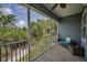 Relaxing screened balcony with comfortable seating and views of lush greenery at 208 Haven Beach Ct, Indian Rocks Beach, FL 33785