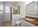 Bathroom with a glass-enclosed shower, decorative mirror, and granite countertop at 208 Haven Beach Ct, Indian Rocks Beach, FL 33785