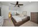 Spacious bedroom with white walls, a ceiling fan, and a dedicated work space with natural lighting at 208 Haven Beach Ct, Indian Rocks Beach, FL 33785