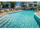 Inviting community pool with ample lounge seating, perfect for relaxation and enjoying the sunny weather at 208 Haven Beach Ct, Indian Rocks Beach, FL 33785
