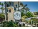 Attractive entry sign for The Cove at Indian Rocks Beach, surrounded by lush tropical landscaping at 208 Haven Beach Ct, Indian Rocks Beach, FL 33785