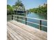 A wooden dock extends over the calm water, providing a serene and inviting space to enjoy the waterfront view at 208 Haven Beach Ct, Indian Rocks Beach, FL 33785