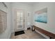 Bright entryway featuring neutral decor, tiled flooring, a bench and shiplap door and sidelight at 208 Haven Beach Ct, Indian Rocks Beach, FL 33785
