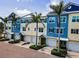 Beautiful townhome exterior with garages, lush tropical landscaping, and coastal architecture in Indian Rocks Beach, Florida at 208 Haven Beach Ct, Indian Rocks Beach, FL 33785