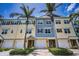 Charming townhome-style condos featuring colorful exteriors, garage parking, and well-maintained landscaping at 208 Haven Beach Ct, Indian Rocks Beach, FL 33785