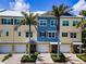 Charming townhome-style condos featuring colorful exteriors, garage parking, and well-maintained landscaping at 208 Haven Beach Ct, Indian Rocks Beach, FL 33785