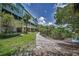 Beautiful backyard of a townhouse complex with lush landscaping and a walking path leading to a waterway at 208 Haven Beach Ct, Indian Rocks Beach, FL 33785