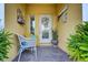 Welcoming front entrance features a decorated door, seating, brick flooring, and a decorated door at 208 Haven Beach Ct, Indian Rocks Beach, FL 33785