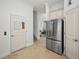 Hallway features stainless steel refrigerator, with easy access to upstairs and other rooms at 208 Haven Beach Ct, Indian Rocks Beach, FL 33785