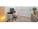 Bright and airy home office featuring a sit stand desk with shuttered windows and comfortable office chair at 208 Haven Beach Ct, Indian Rocks Beach, FL 33785