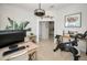 Bright home office featuring modern artwork, dual monitors, exercise bike, and tile floors at 208 Haven Beach Ct, Indian Rocks Beach, FL 33785
