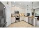 Well-lit kitchen with stainless steel appliances and island, transitioning into the living space at 208 Haven Beach Ct, Indian Rocks Beach, FL 33785