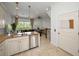 Open-concept kitchen with island and stainless steel dishwasher, flowing into the living room at 208 Haven Beach Ct, Indian Rocks Beach, FL 33785