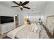 Bright main bedroom features a decorative ceiling fan, an ensuite bath, and home office area with shuttered windows at 208 Haven Beach Ct, Indian Rocks Beach, FL 33785