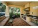 Outdoor kitchen and grilling area featuring a grill, sink, and counter space for outdoor cooking and entertaining at 208 Haven Beach Ct, Indian Rocks Beach, FL 33785