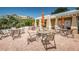 Comfortable outdoor seating with umbrellas and tables provide a great space to relax and socialize by the pool at 208 Haven Beach Ct, Indian Rocks Beach, FL 33785