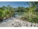 Private water access surrounded by lush landscaping provides a serene spot for waterfront enjoyment and relaxation at 208 Haven Beach Ct, Indian Rocks Beach, FL 33785