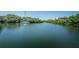 Scenic view of the waterfront from the wooden dock area, perfect for enjoying the natural beauty of the community at 208 Haven Beach Ct, Indian Rocks Beach, FL 33785