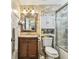 Updated bathroom boasts sleek vanity, stylish mirror, and glass-enclosed shower at 2818 Lorraine St, Tampa, FL 33614