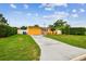 Single-story home with a well-manicured lawn and extended driveway at 2818 Lorraine St, Tampa, FL 33614
