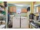 Laundry room with washer, dryer, and convenient overhead cabinets at 2818 Lorraine St, Tampa, FL 33614