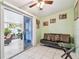Cozy living room features tiled floor, a modern ceiling fan, and sliding doors leading to the patio at 2818 Lorraine St, Tampa, FL 33614