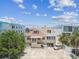 Aerial view of the home surrounded by trees and an empty parking lot at 30 Gulf Blvd, Indian Rocks Beach, FL 33785