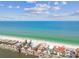 Breathtaking aerial view of a beachfront property surrounded by the ocean and a tranquil river, with a blue sky backdrop at 30 Gulf Blvd, Indian Rocks Beach, FL 33785