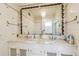 Charming bathroom with double sinks, ornate mirror, and decorative floral tile at 30 Gulf Blvd, Indian Rocks Beach, FL 33785