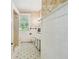 Bathroom featuring mosaic tile shower, tiled walls, and a window with blind at 30 Gulf Blvd, Indian Rocks Beach, FL 33785