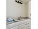 Bathroom with white cabinets and marble countertop at 30 Gulf Blvd, Indian Rocks Beach, FL 33785