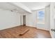 Bedroom features wood-look flooring, a bright window, and white walls at 30 Gulf Blvd, Indian Rocks Beach, FL 33785