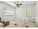 Bedroom featuring a ceiling fan and windows with mini blinds at 30 Gulf Blvd, Indian Rocks Beach, FL 33785
