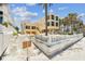 Exterior view of a three-story home by the beach, featuring large windows and tall palm trees at 30 Gulf Blvd, Indian Rocks Beach, FL 33785
