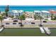 Beautiful street view of beach homes with palm trees, parked cars, and waterfront access at 30 Gulf Blvd, Indian Rocks Beach, FL 33785