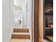 Hallway featuring hardwood steps and an adjacent library with built-in shelves at 30 Gulf Blvd, Indian Rocks Beach, FL 33785