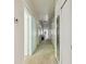 Long hallway with multiple doors, light fixtures, and carpet leading to a piano in the distance at 30 Gulf Blvd, Indian Rocks Beach, FL 33785