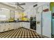 Cozy kitchen featuring original cabinets, checkerboard flooring, and white appliances at 30 Gulf Blvd, Indian Rocks Beach, FL 33785