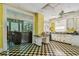 Vintage kitchen featuring unique black and yellow checkerboard flooring and ample natural light at 30 Gulf Blvd, Indian Rocks Beach, FL 33785