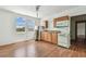 Compact kitchen with wood cabinets, white appliances, and a double window providing natural light at 30 Gulf Blvd, Indian Rocks Beach, FL 33785