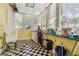 A bright laundry room with black and white tile flooring and ample natural light at 30 Gulf Blvd, Indian Rocks Beach, FL 33785