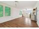 Spacious living room with hardwood floors, two windows, and wall art at 30 Gulf Blvd, Indian Rocks Beach, FL 33785