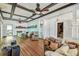 Spacious living room featuring beautiful hardwood floors, beamed ceilings, and abundant natural light at 30 Gulf Blvd, Indian Rocks Beach, FL 33785