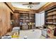 Living Room showcasing built-in bookcase, wood paneling, ceiling fan, and carpet floors at 30 Gulf Blvd, Indian Rocks Beach, FL 33785