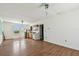 Open-concept living room with hardwood floors and attached kitchen area featuring white walls and natural light at 30 Gulf Blvd, Indian Rocks Beach, FL 33785