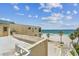 Rooftop view of ocean and beach, plus adjacent building at 30 Gulf Blvd, Indian Rocks Beach, FL 33785
