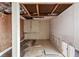 Unfinished room offers customization, featuring exposed beams and peeling wallpaper at 30 Gulf Blvd, Indian Rocks Beach, FL 33785
