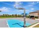 Outdoor basketball court featuring blue accents, green grass, and nearby neighborhood amenities at 3060 Mountain Spruce Ter, Wesley Chapel, FL 33543